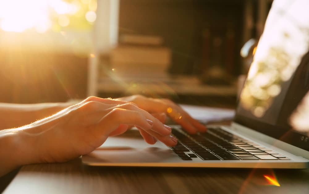 mains d'une femme en train d'envoyer un message à Anne-Sophie Lapix depuis son ordinateur